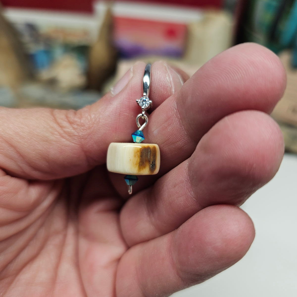 Woolly Mammoth fossil ivory earrings showing polished beads and Swarovski Aurora crystals, crafted by Kristin R Park at Ice Age Treasures.