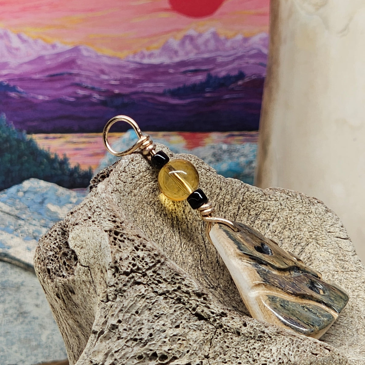 Side view of Heart Totem mammoth fossil ivory pendant showing its thickness, wire bail and citrine bead, crafted by Kristin R Park at Ice Age Treasures.