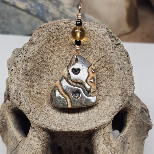 Woolly mammoth fossil ivory Heart Totem pendant with carved black hearts and a citrine bead, crafted by Kristin R Park at Ice Age Treasures.