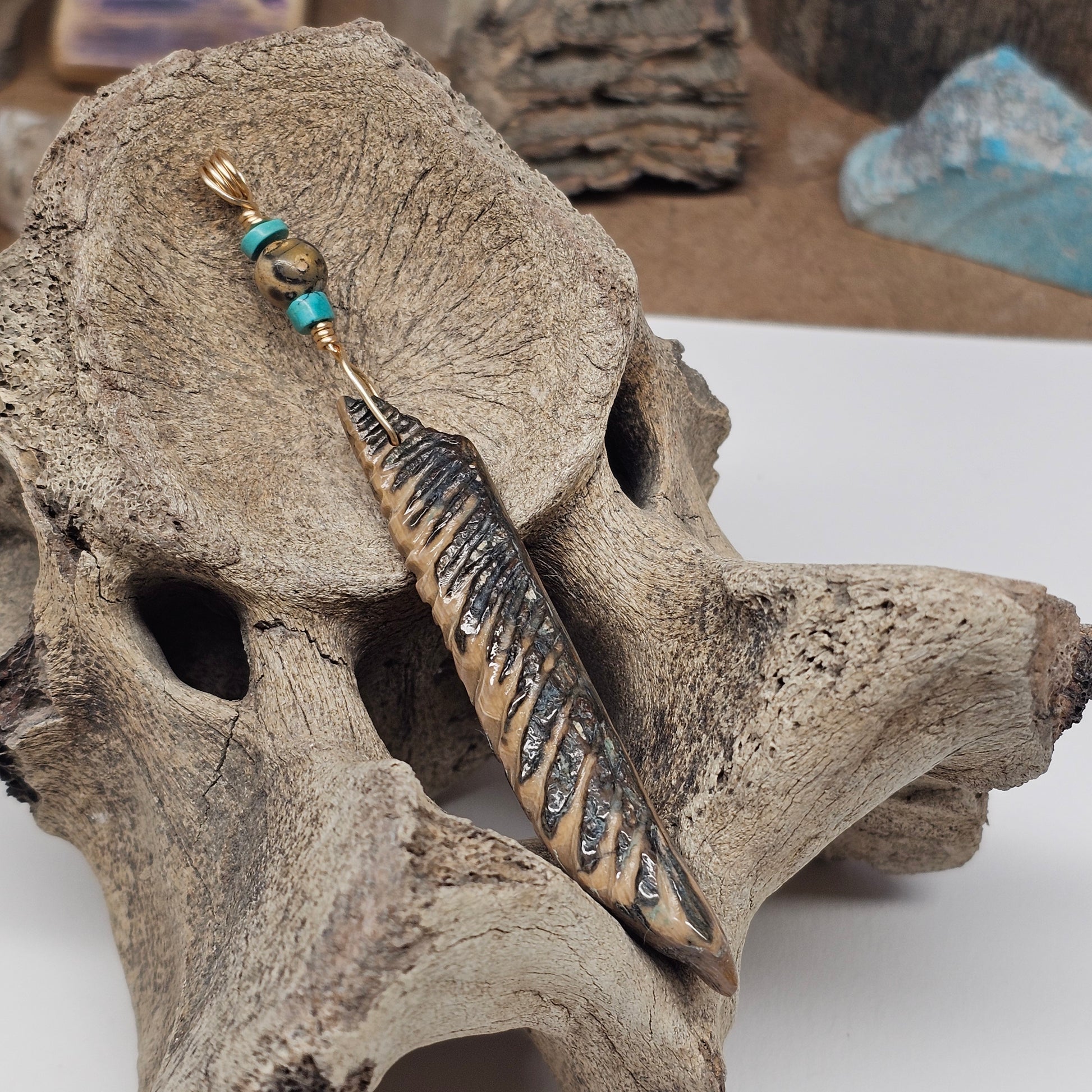 Woolly Mammoth Fossil Ivory Carved Feather Pendant with materials sourced at The Boneyard Alaska Exclusively